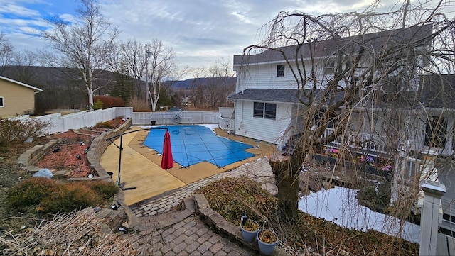 view of pool featuring a mountain view and a patio