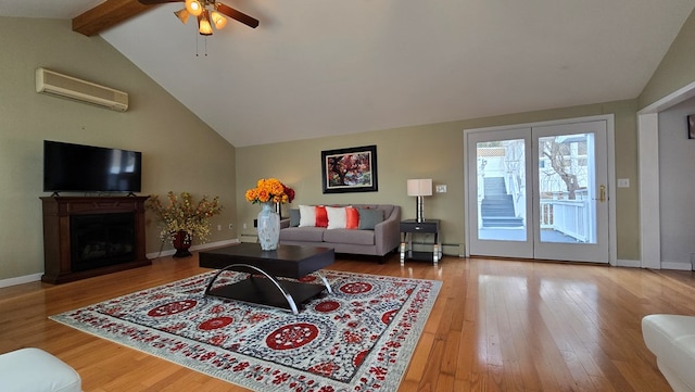 living room with an AC wall unit, beamed ceiling, wood-type flooring, a baseboard radiator, and ceiling fan