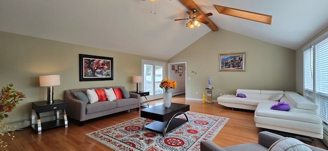 living room with beamed ceiling, wood-type flooring, a healthy amount of sunlight, and ceiling fan