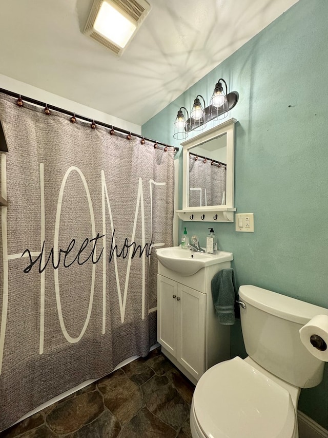 bathroom featuring vanity and toilet