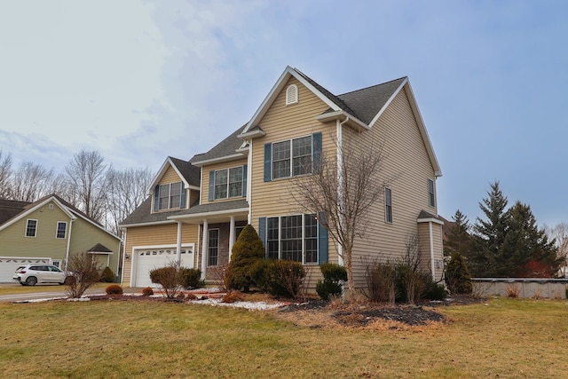 view of front of house with a garage and a front yard