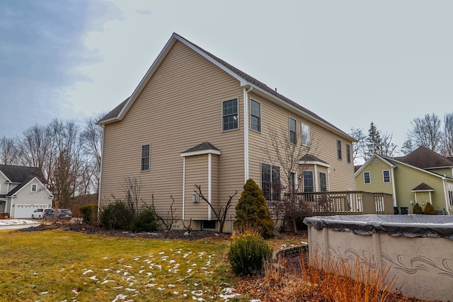 view of home's exterior featuring a garage, a yard, and a covered pool