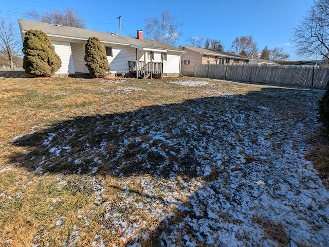 back of property featuring a lawn