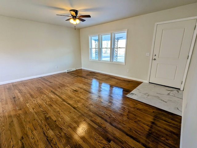 unfurnished room with dark hardwood / wood-style floors and ceiling fan