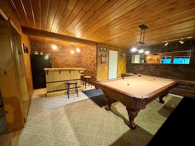 rec room with brick wall, indoor bar, light carpet, track lighting, and wooden ceiling