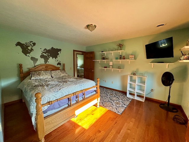 bedroom with hardwood / wood-style flooring