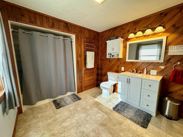 bathroom featuring vanity, toilet, wooden walls, and a shower with shower curtain