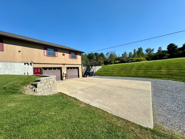 view of home's exterior featuring a garage and a lawn