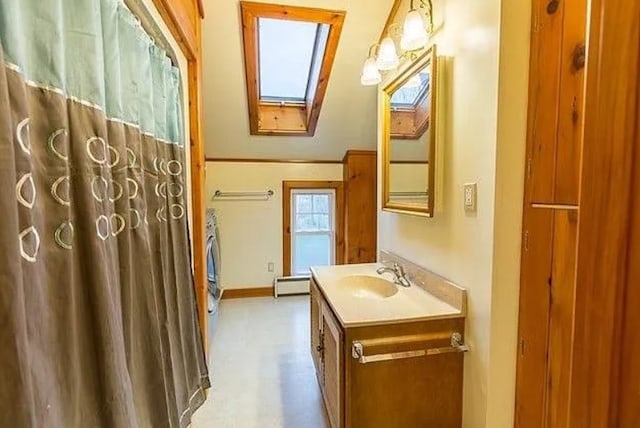 bathroom featuring vanity, a skylight, and a baseboard heating unit