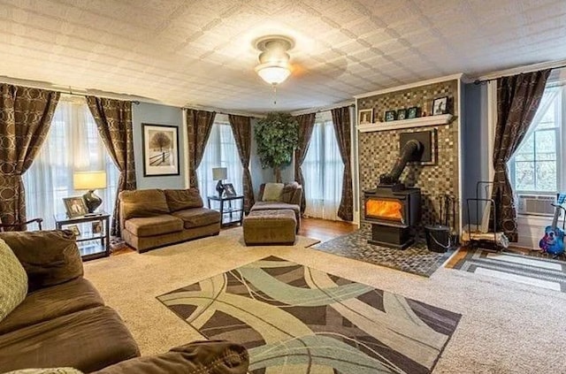 living area with carpet flooring and a wood stove