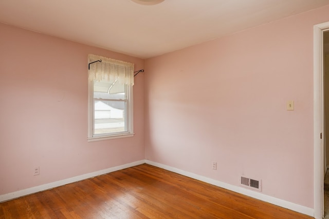 spare room featuring hardwood / wood-style floors