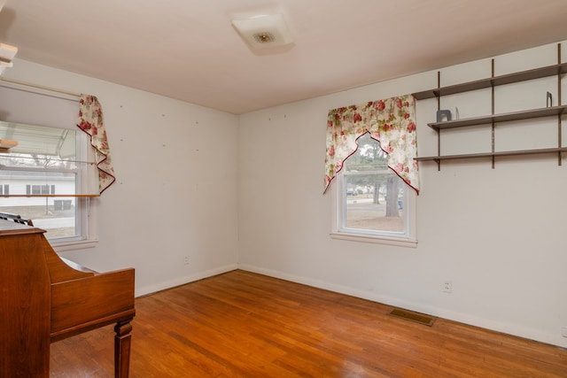 spare room with wood-type flooring