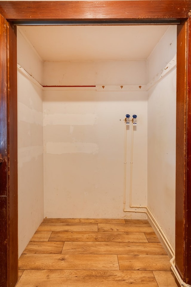 laundry area with hardwood / wood-style flooring and washer hookup