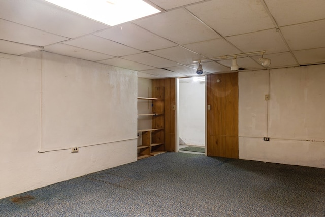 basement with a drop ceiling and carpet floors