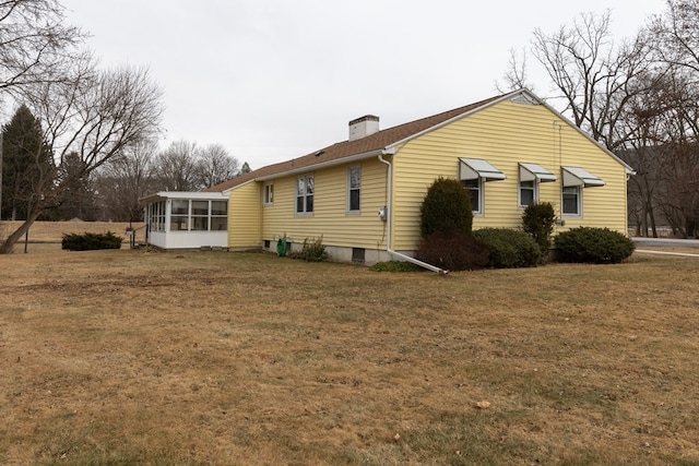 view of home's exterior featuring a yard and a sunroom