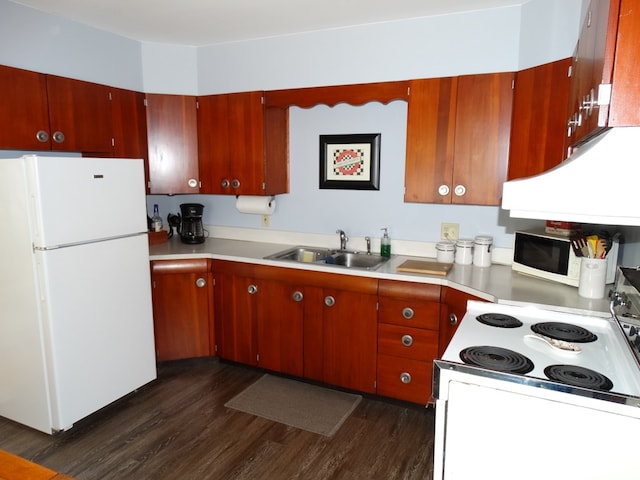 kitchen with white appliances, dark hardwood / wood-style floors, and sink