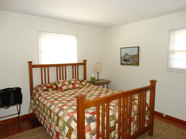 bedroom with dark hardwood / wood-style floors