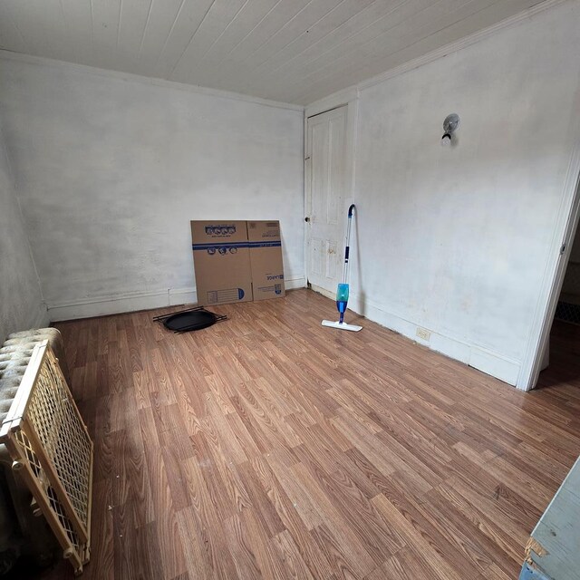 empty room with wood-type flooring and wood ceiling