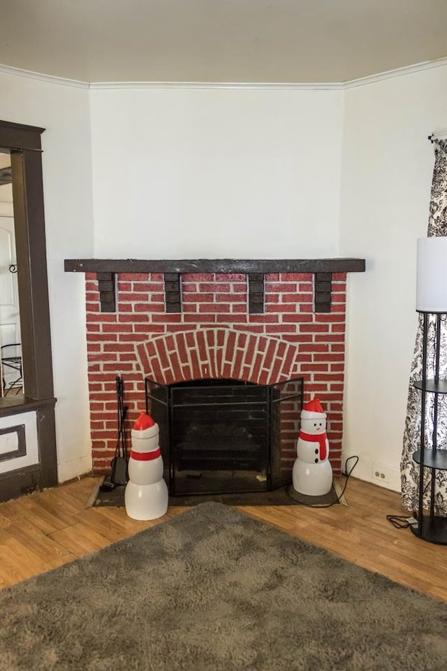 interior details featuring crown molding, a fireplace, and hardwood / wood-style floors