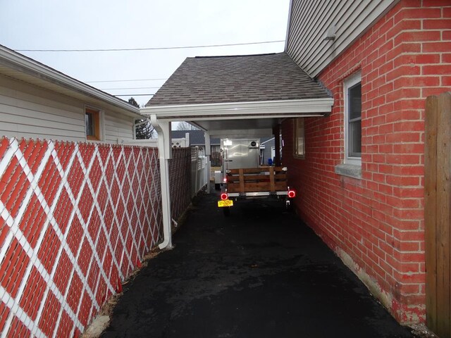 view of side of home with a carport