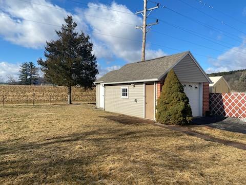 garage featuring a lawn