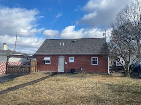 back of house with a lawn