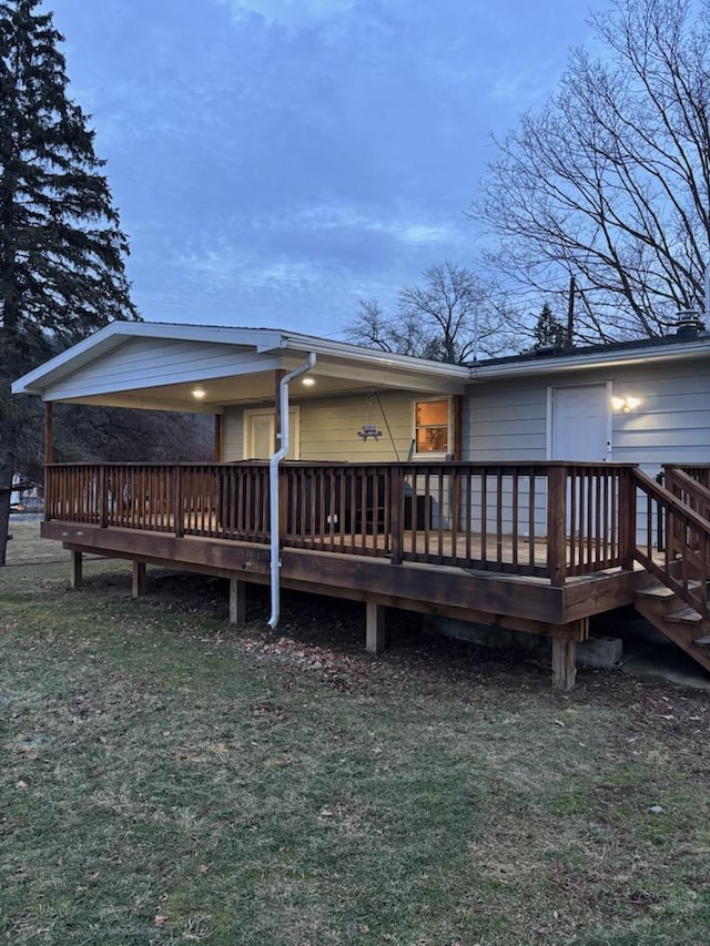 back of house with a wooden deck and a yard