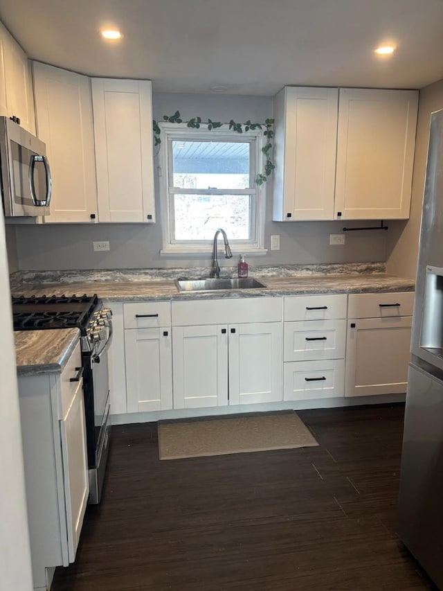 kitchen featuring white cabinetry, appliances with stainless steel finishes, and sink