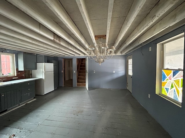 interior space featuring a wealth of natural light, gray cabinets, wood-type flooring, and white refrigerator