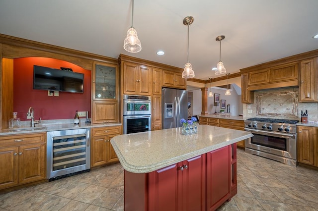 kitchen featuring wine cooler, sink, a center island, pendant lighting, and stainless steel appliances