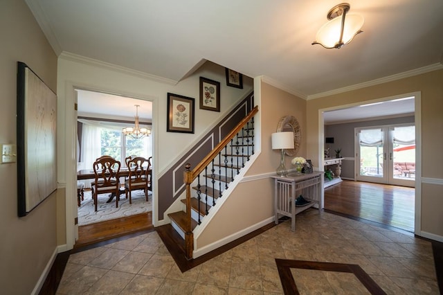 stairway with ornamental molding, an inviting chandelier, and french doors