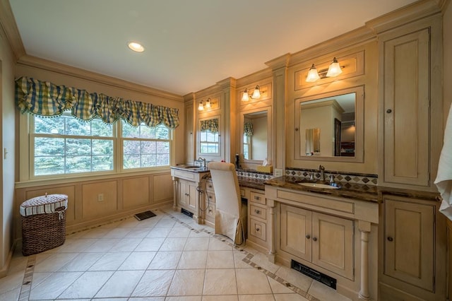 bathroom featuring tile patterned flooring, crown molding, and vanity