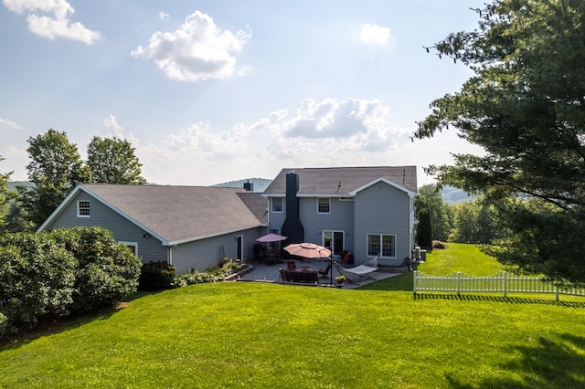 rear view of house featuring a gazebo, a lawn, and a patio