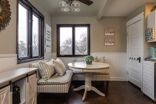 dining room with breakfast area, dark hardwood / wood-style flooring, plenty of natural light, and beamed ceiling