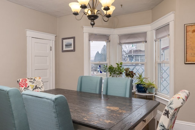 dining area featuring an inviting chandelier