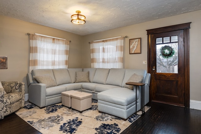 living room featuring hardwood / wood-style flooring and a textured ceiling