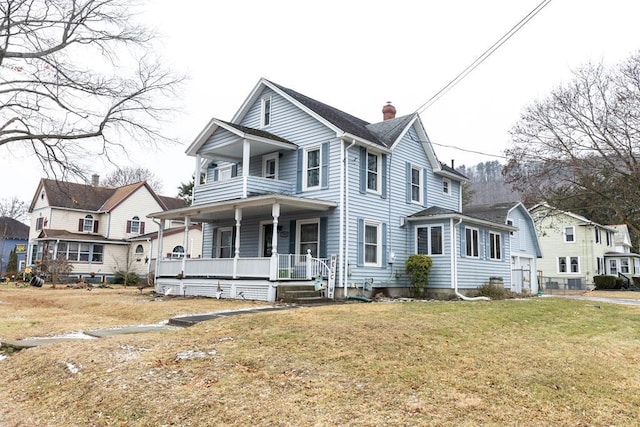 view of front of home with covered porch and a front lawn