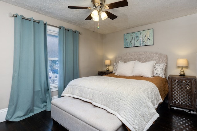 bedroom featuring ceiling fan, a textured ceiling, and dark hardwood / wood-style flooring