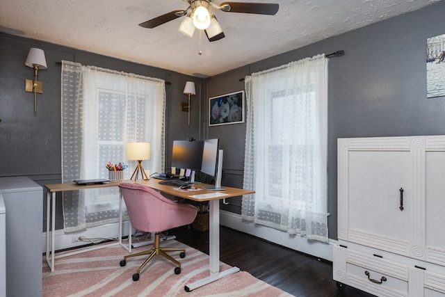 office featuring ceiling fan, dark hardwood / wood-style floors, washer / clothes dryer, and a textured ceiling