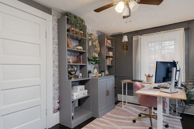 office space with dark hardwood / wood-style flooring, ceiling fan, a baseboard radiator, and a textured ceiling