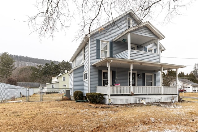 view of front of property with a balcony and covered porch