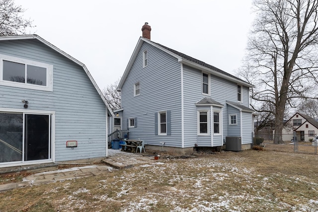 rear view of house featuring central AC