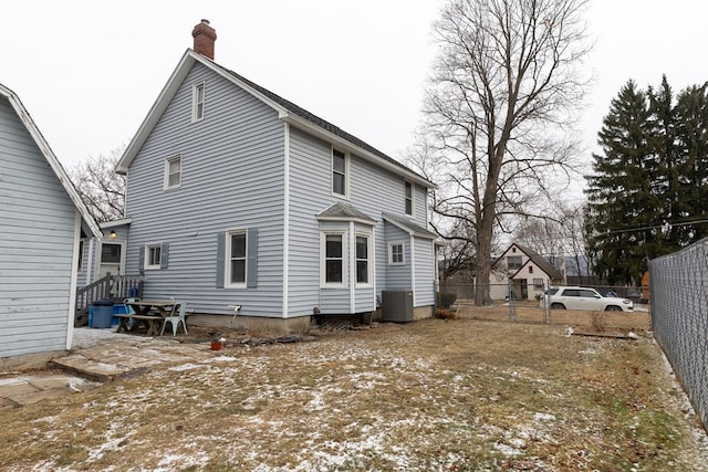 rear view of house with central air condition unit