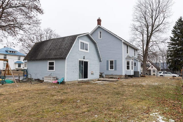 back of house featuring a yard and central AC