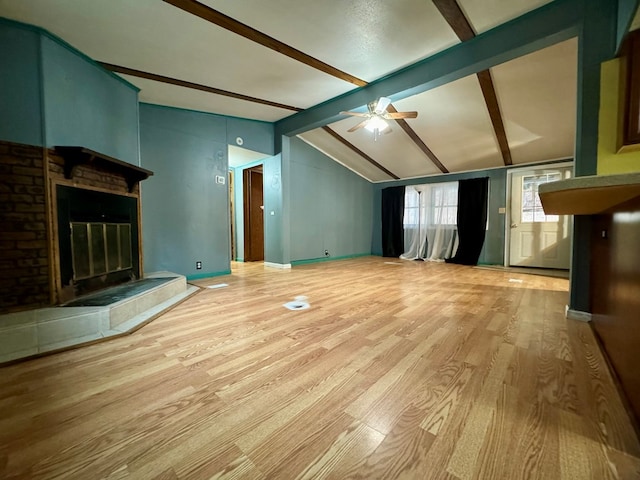 unfurnished living room with hardwood / wood-style flooring, ceiling fan, and lofted ceiling with beams