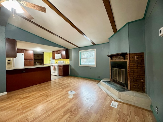 unfurnished living room with sink, lofted ceiling with beams, ceiling fan, and light wood-type flooring