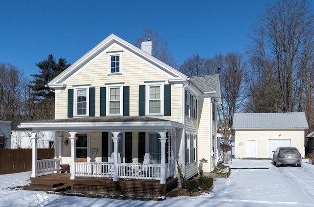 view of front of home featuring an outbuilding, a porch, and a garage