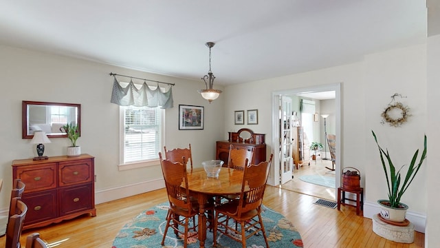 dining space with light hardwood / wood-style flooring