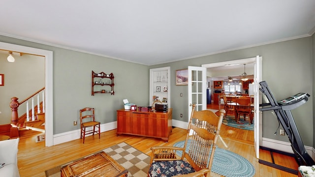 interior space with hardwood / wood-style flooring, crown molding, and french doors