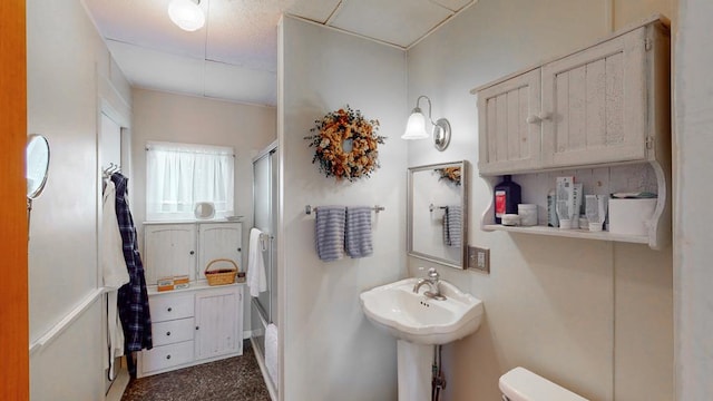 bathroom featuring sink, toilet, and walk in shower